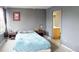 Main bedroom with double bed, gray walls, and ensuite bathroom access at 762 Mockingbird Ln, Brighton, CO 80601