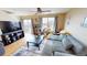 Living room with sectional sofa, TV, and access to backyard patio at 762 Mockingbird Ln, Brighton, CO 80601