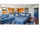 Comfortable living room featuring a sectional sofa and access to the kitchen at 6988 S Riverwood Way, Aurora, CO 80016
