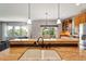 Kitchen features granite countertops and double sink with views to Gathering room at 6988 S Riverwood Way, Aurora, CO 80016