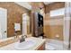 Bathroom with shower/tub combo, sink, and vanity at 6988 S Riverwood Way, Aurora, CO 80016