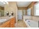 Bathroom with double vanity, soaking tub, and walk-in shower at 6988 S Riverwood Way, Aurora, CO 80016