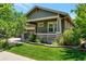 House exterior showcasing green siding and landscaping at 6988 S Riverwood Way, Aurora, CO 80016