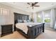 Main bedroom with large bed, ceiling fan, and ample natural light at 6988 S Riverwood Way, Aurora, CO 80016