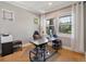 Home office with desk, chair, and large windows at 6988 S Riverwood Way, Aurora, CO 80016