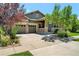 House exterior, two-car garage, and landscaped yard at 6988 S Riverwood Way, Aurora, CO 80016