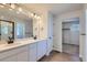 Double vanity bathroom with modern finishes and access to closet at 5918 Red Barn Ave, Mead, CO 80504