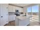 Modern kitchen with island, stainless steel appliances, and view to backyard at 5918 Red Barn Ave, Mead, CO 80504