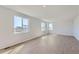 Spacious living room featuring light walls and wood-look flooring at 5918 Red Barn Ave, Mead, CO 80504