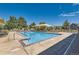 Community swimming pool with lounge chairs and shaded seating areas at 11250 Florence St # 19A, Commerce City, CO 80640