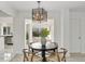 Modern dining room with a black table, light-colored chairs and a view of the backyard at 2749 S Glencoe St, Denver, CO 80222