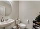 Clean and simple powder room with pedestal sink and toilet at 2262 Monte Vista St, Fort Lupton, CO 80621