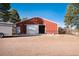 Red barn with large white doors and horse stalls at 3074 County Road 166, Elizabeth, CO 80107