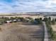 Aerial view of a property with multiple buildings and a long driveway at 3074 County Road 166, Elizabeth, CO 80107