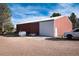 Large red barn with white doors and fuel tanks at 3074 County Road 166, Elizabeth, CO 80107