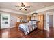 Main bedroom with wood floors, built-in shelving, and private access to the bathroom at 37159 Pheasant Run, Elizabeth, CO 80107