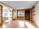 Bright bedroom with wood-paneled walls, large bookcase and floating shelves, and French doors to living room at 2441 S Xanadu Way # D, Aurora, CO 80014