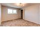Spacious bedroom with neutral walls, carpeting, and window at 7010 Utica St # E, Westminster, CO 80030