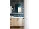 Modern bathroom with a blue tile wall, a large mirror, and light wood vanity at 800 Bonnie Brae Blvd, Denver, CO 80209