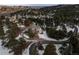 Elevated view of the home's front, circular driveway, and snow-covered landscape at 812 Willobe Way, Golden, CO 80401