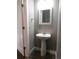 Elegant powder room with pedestal sink and textured wallpaper at 1179 S Sherman St, Denver, CO 80210