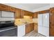 Galley kitchen with wood cabinets and appliances at 4570 E Yale Ave # 706, Denver, CO 80222