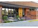 Condominium building's entrance with unique gold doors and landscaping at 4570 E Yale Ave # 706, Denver, CO 80222