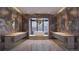 Luxurious bathroom with double vanities, a soaking tub, and expansive mountain views at 7499 Preservation Trl, Parker, CO 80134