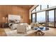 Main bedroom features a plush bed, sitting area, and access to a private balcony at 7499 Preservation Trl, Parker, CO 80134