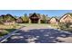 Elegant clubhouse with circular driveway and stone facade at 7499 Preservation Trl, Parker, CO 80134