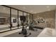 Modern home gym featuring cardio equipment and strength training area at 7499 Preservation Trl, Parker, CO 80134
