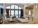 Living room with large windows, mountain views, and kitchen access at 7499 Preservation Trl, Parker, CO 80134