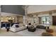Open concept living room with stone fireplace and stylish furniture at 7499 Preservation Trl, Parker, CO 80134