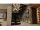 Modern staircase with sleek black railing and stone wall accents at 7499 Preservation Trl, Parker, CO 80134
