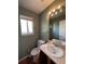 Clean bathroom with single sink vanity, toilet and window at 21620 E Crestline Ln, Centennial, CO 80015