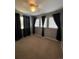 Bright bedroom with three windows, dark curtains and ceiling fan at 21620 E Crestline Ln, Centennial, CO 80015