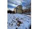 Two-story yellow house with a snow-covered lawn and landscaping at 21620 E Crestline Ln, Centennial, CO 80015