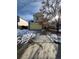 Two-story yellow house with a snow-covered driveway and landscaping at 21620 E Crestline Ln, Centennial, CO 80015
