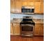 Kitchen with stainless steel appliances and wood cabinets at 21620 E Crestline Ln, Centennial, CO 80015