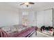 Cozy bedroom with ceiling fan, closet, and carpeted floors at 5989 E Monument Dr, Castle Rock, CO 80104