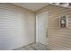 Exterior condo entryway with white door and neutral siding at 14171 E Jewell Ave # 101, Aurora, CO 80012