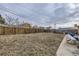 Large backyard with wooden fence, shed, and patio area at 9030 Hickory Pl, Thornton, CO 80229