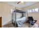 Bedroom with a bunk bed, office chair, and ample natural light at 9030 Hickory Pl, Thornton, CO 80229