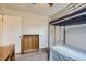 Small bedroom with a bunk bed and built-in shelving at 9030 Hickory Pl, Thornton, CO 80229