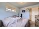 Light blue bedroom with a queen bed and ample closet space at 9030 Hickory Pl, Thornton, CO 80229