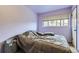 Bright bedroom with a double bed and window coverings at 9030 Hickory Pl, Thornton, CO 80229