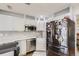 Modern kitchen with stainless steel appliances and white cabinets at 9030 Hickory Pl, Thornton, CO 80229