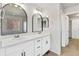 Bright bathroom with double sinks and arched mirrors at 21186 E Layton Ave, Aurora, CO 80015