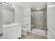 Updated bathroom with white vanity, walk-in shower, and tile floor at 21186 E Layton Ave, Aurora, CO 80015