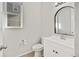 Modern bathroom with white vanity and arched mirror at 21186 E Layton Ave, Aurora, CO 80015